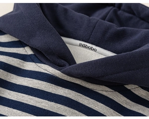 Detail of striped kids hoodie neckline featuring soft inner fleece lining and logo