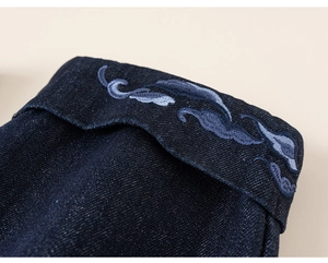 Close-up of fine embroidery and premium twill denim texture on children's winter sweater