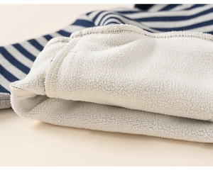 Close-up of thick navy blue striped kids sweatshirt with warm white fleece lining