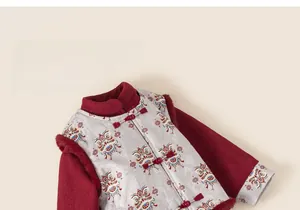 Detailed view of Chinese New Year vest featuring traditional knot buttons and lion pattern