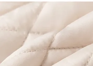 Close-up of diamond quilted texture on beige thick padded cotton vest for kids