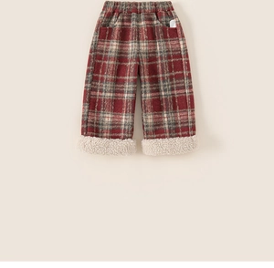 Detail of children's red plaid fleece trousers with warm sherpa fleece cuffs