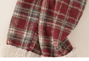 Detail of children's plaid pants showing thick white fleece lining and soft fabric texture