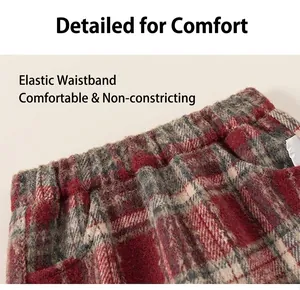Detail of red and grey plaid trousers featuring thick brushed fabric and elastic waistband