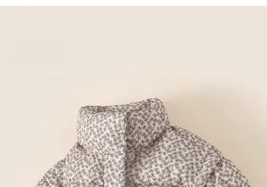 Detail of floral print on padded jacket with high collar and soft fabric texture
