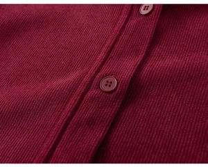 Detailed close-up of wine red corduroy texture and matching buttons on boys' Chinese vest