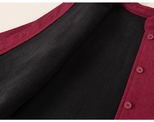 Detail of burgundy corduroy vest with thick black fleece lining and resin buttons