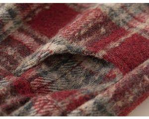 Detail of red and grey plaid wool fabric texture with thick brushed finish and pocket
