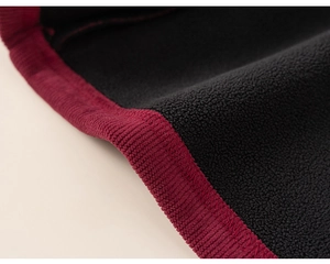 Close-up of thick fleece lining and ribbed burgundy edge on a warm Chinese style suit