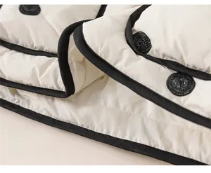 Detail of white quilted jacket hem with black polka dots and high-quality piping
