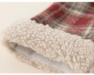Close-up of red plaid girl sweater with thick white fleece lining for warmth