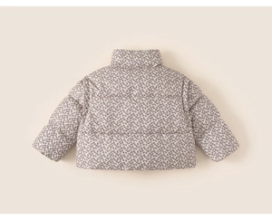 Detail of floral printed puffer jacket for girls featuring high collar and quilted texture