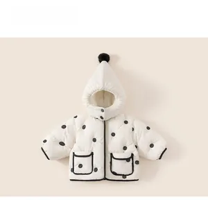 Detailed view of white polka dot padded coat with pointed hood and faux fur pompom for kids