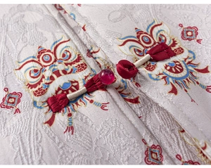 Close-up of traditional Chinese button and embroidered lion patterns on silk fabric