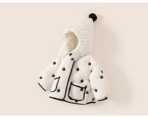 Close-up of baby winter hooded coat with black polka dots and fluffy pom-pom detail