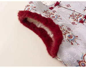 Detailed view of Chinese style children's vest with red faux fur trim and embroidery