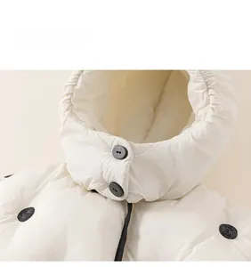 Detail view of toddler polka dot jacket featuring secure black buttons and warm padded fabric