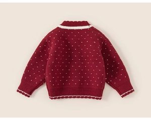 Back view of red girls knit sweater with white heart pattern and striped trim details