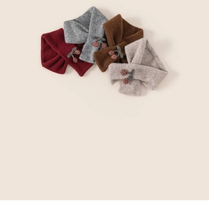 Detail showing knitted texture and cute cherry pattern on thick crisscross neck warmers