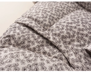 Detail of floral quilted fabric texture on girls winter padded jacket with macro focus