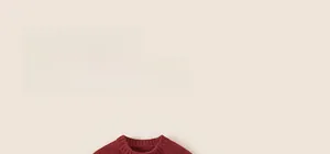 Close-up of chunky knit texture and round neck detail on red festive kids' sweater