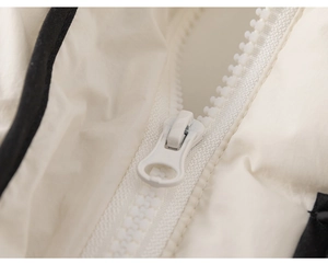 Detail of high-quality white resin zipper and soft quilted fabric on a toddler winter coat