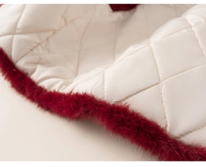 Detail of quilted diamond pattern and red faux fur trim on a warm kid's winter outfit
