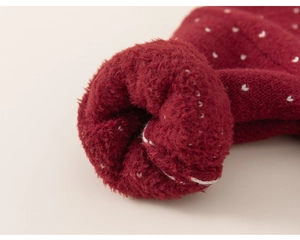 Detailed macro shot of thick red knit fabric with soft fleece lining for warmth