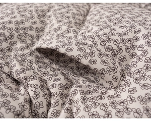 Detailed macro view of quilted floral fabric texture and stitching on kid's cotton jacket
