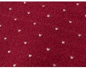 Close-up of soft red knitted fabric featuring delicate white heart patterns for children