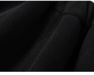 Close-up of durable flat seam and high-quality black knitted fabric on children's set