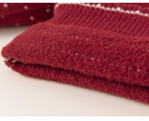 Close-up of red thick knit fabric with soft texture and white stripe detail for kids