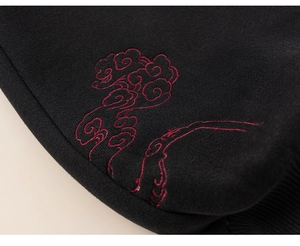 Macro detail of red auspicious cloud embroidery on thick black fabric of kids' suit
