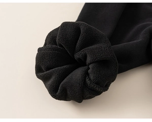 Close-up of thick fleece lining on black children's clothing for thermal warmth