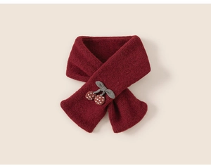 Detail of dark red knit scarf featuring cherry ornaments and a grey bow for children