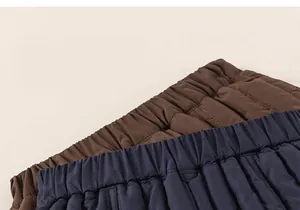 Detail of quilted thermal kids trousers with elastic waistband and windproof fabric texture