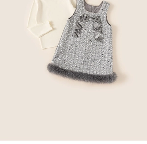 Detail view of girl's tweed dress with sequin fabric and luxury pearl neck trim