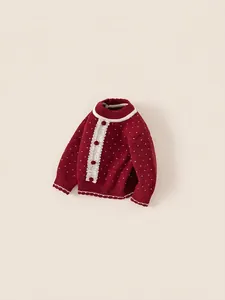 Red knit sweater for girls with white dots, lace trim and pom-pom buttons