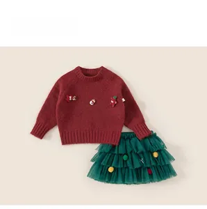 Detailed view of kids' Christmas red knit sweater and green tiered mesh tutu skirt set