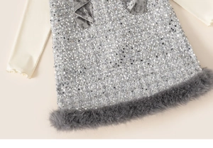 Detail of silver sequin dress with dark grey faux fur trim and velvet ruffle neckline