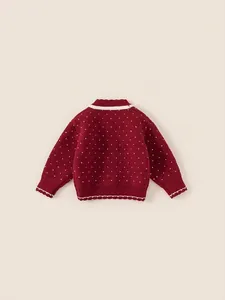 Girls burgundy knitted sweater featuring white heart patterns and contrast trim