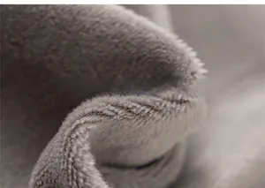 Macro view of thick grey fleece lining on kids' tweed outfit for warm comfort