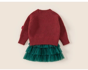 Detail of red cable-knit sweater and green layered tulle skirt for holiday outfits