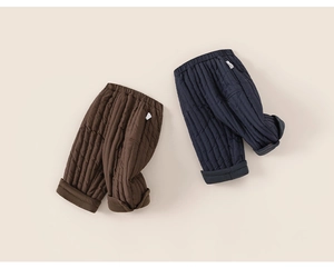 Detailed view of quilted winter trousers in dark brown and navy blue with elastic waist