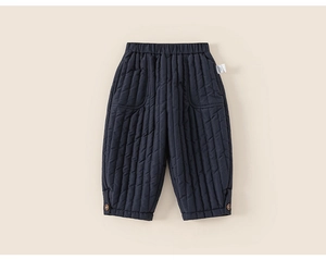 Close-up of quilted kids' thick winter trousers in deep blue with elastic waist details