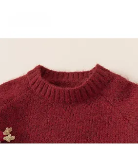 Detailed view of dark red rib knit sweater collar with fuzzy mohair texture