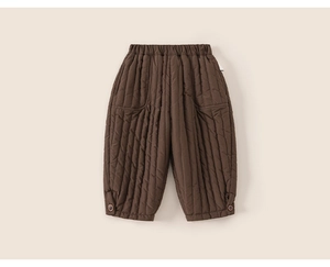 Detailed macro view of quilted thermal winter trousers for boys with elastic waistband