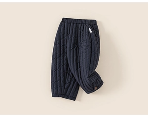 Detailed view of kids navy quilted padded trousers with elastic waist and button hem detail