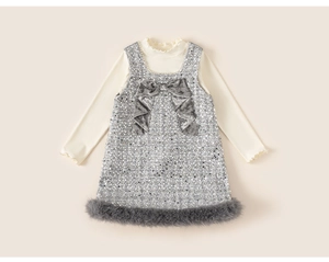 Detail of girls' sequin pinafore dress with velvet bow and faux fur trim set