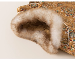 Detail of golden jacquard silk fabric with traditional patterns and brown faux fur lining